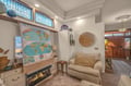 Sink into the plush seating by your warm fireplace, where eclectic décor and soft lighting create your perfect retreat for unwinding after island adventures.