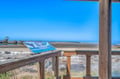 Coastal viewing area with interpretive signage overlooking pristine beaches and clear blue waters.