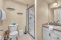 Step into your pristine bathroom where soft towels await and a glass-enclosed shower promises refreshing moments during your stay.