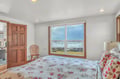 Wake up to breathtaking ocean waves right outside your bedroom window, where cozy floral bedding meets stunning coastal views.