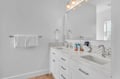 Refresh in your pristine en-suite with dual sinks, soft lighting, and plush towels ready for your comfort.