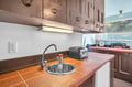 Your fully equipped kitchen features warm tile countertops and classic cabinetry, perfect for preparing meals during your stay.
