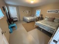 Settle into your comfortable twin bedroom featuring two cozy beds with coastal-themed linens and thoughtful touches like wall art and a work desk.